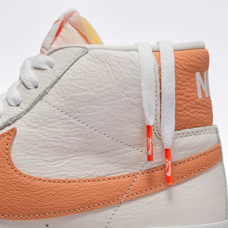 Nike shoes with orange 2025 swoosh